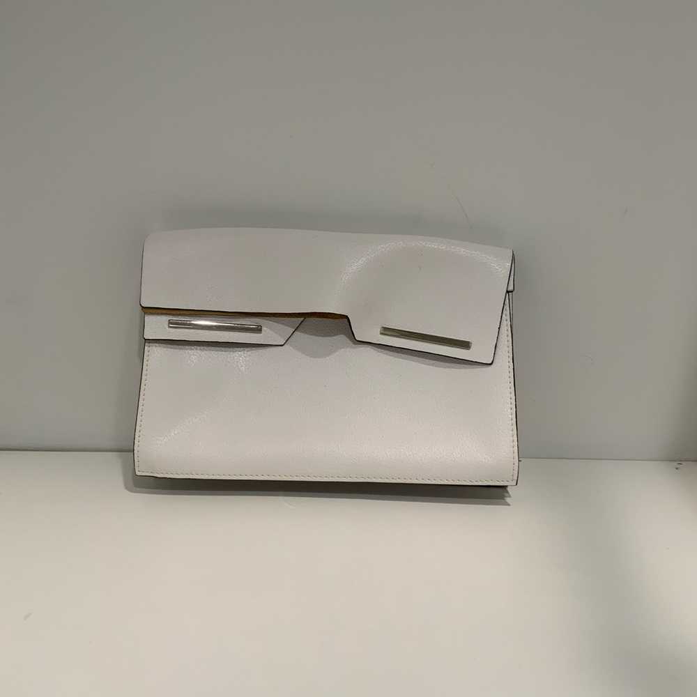 Woman’s white clutch